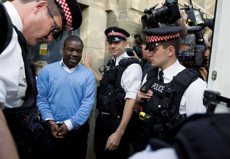 Kweku Adoboli (second from left), was charged Friday with acts of fraud and false accounting dating back to 2008. (Associated Press)