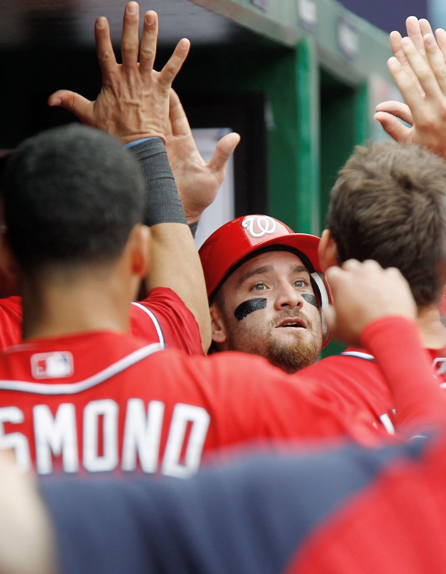 Washington's Jonny Gomes celebrates with teammates after scoring a run on a sacrifice by Chris Marrero during the second inning of Sunday's win. (Associated Press)