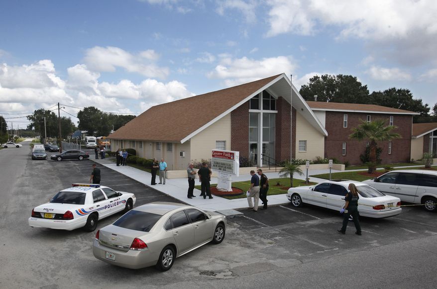 Lakeland police and Polk County sheriff's deputies investigate a shooting in Lakeland, Fla. on Sunday, Sept. 18, 2011. A gunman killed his wife at their Florida home and then burst through the front door of a nearby church on Sunday, wounding a pastor and associate pastor before parishioners tackled him, authorities and relatives said. (AP Photo/The Lakeland Ledger, Pierre DuCharme)