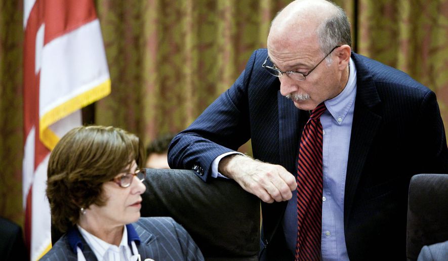 A TAXING MOVE: D.C. Council member Mary M. Cheh confers with fellow council member Phil Mendelson on Tuesday. Mr. Mendelson led the charge in a push to increase the city&#39;s income-tax rate on high-income earners. (T.J. Kirkpatrick/The Washington Times)