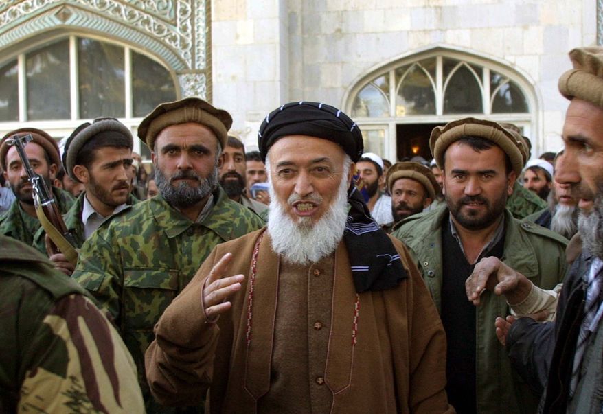 ** FILE ** This Friday, Nov. 23, 2001, file photo shows former Afghan President Burhanuddin Rabbani as he emerges from the Pul-e-Khishti mosque after Friday prayers, surrounded by United Front bodyguards and supporters, in the capital Kabul, Afghanistan. A Kabul police official said Tuesday, Sept. 20, 2011, that Mr. Rabbani was killed by a suicide bomber who had explosives in his turban. (AP Photo/Brennan Linsley)