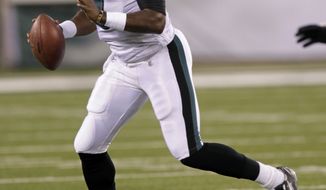 Philadelphia Eagles&#x27; quarterback Vince Young rolls out during the first quarter of an NFL preseason game between Philadelphia and the New York Jets, Sept. 1, 2011, in East Rutherford, N.J. (AP Photo/Seth Wenig)