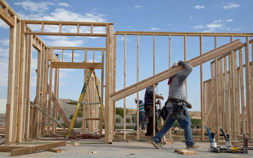A carpenter carries lumber while framing a new home in Las Vegas on Thursday, Sept. 8, 2011. (AP Photo/Julie Jacobson)