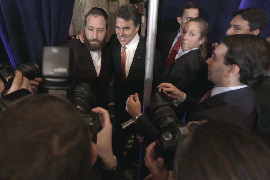 Republican presidential candidate, Texas Gov. Rick Perry, second from left, poses for a photo with a supporter after a news conference in New York, Tuesday, Sept. 20, 2011. (AP Photo/Mary Altaffer)