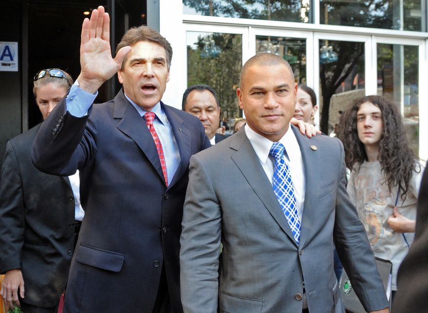 Republican presidential candidate Texas Gov. Rick Perry, left, heads to his vehicle after exiting the Papasito Restaurant in the Inwood section of the Manhattan borough of New York, Monday, Sept. 19, 2011. Wading into a tense foreign policy dispute, Mr. Perry and former Gov. Mitt Romney on Tuesday criticized the Palestinian Authority's effort to seek a formal recognition of statehood by the U.N. General Assembly. The GOP rivals also used the jockeying at the U.S. to assail President Barack Obama's policy toward Israel. (AP Photo/Louis Lanzano)