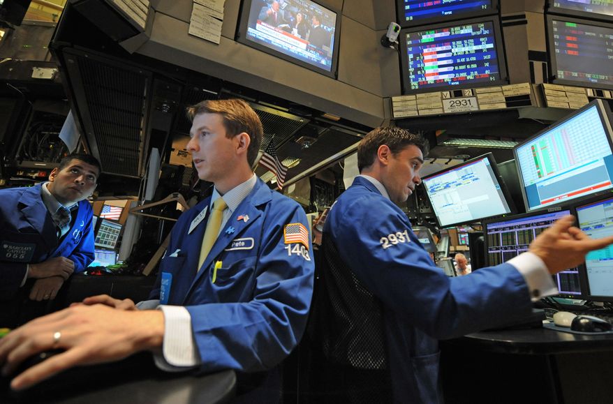 Traders work on the floor of the New York Stock Exchange on Thursday, Sept. 22, 2011, in New York. Stocks were sharply lower worldwide over indications that the global economy is in for a long slump. (AP Photo/Louis Lanzano)