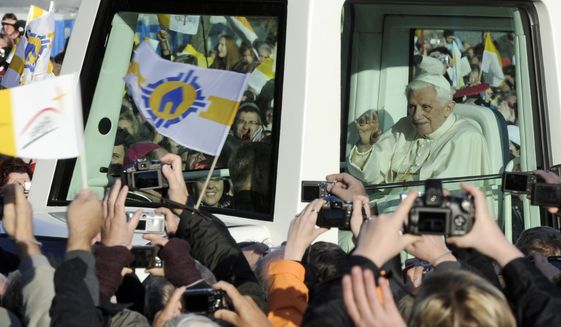 Pope Benedict XVI arrives in his popemobile to celebrate an open air mass in front of the St. Mary&#x27;s cathedral in Erfurt, central Germany, Saturday, Sept. 24, 2011. Pope Benedict XVI is on a four-day official visit to his homeland Germany. (AP Photo/Jens Meyer)