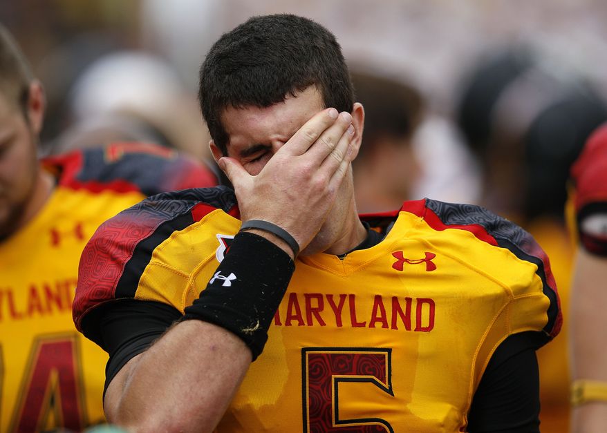 Maryland quarterback Danny O'Brien wipes his face while standing on the sideline in the second half against Temple. Temple won 38-7, as Maryland barely avoided its first home shutout since 1997. (AP Photo/Patrick Semansky)