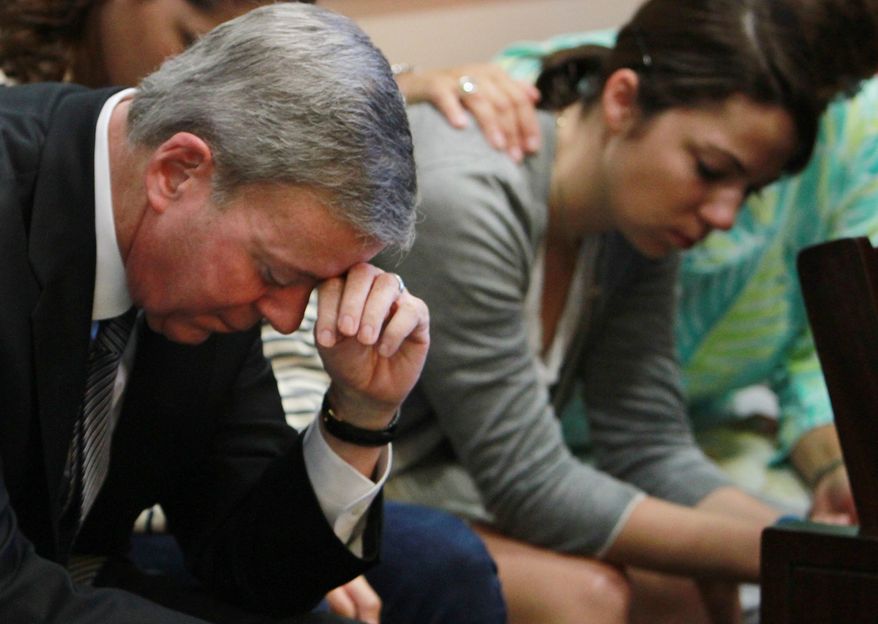 Robert Ward, left, and his daughter Mallory, wait as the jury in the Wards' murder trial returns to court for a second day of deliberations Saturday, Sept. 24, 2011. Ward, a millionaire developer, is charged with second-degree murder in the death of his wife Diane, who was shot in the bedroom of their Isleworth mansion in 2009. (AP Photo/Pool, Red Huber)