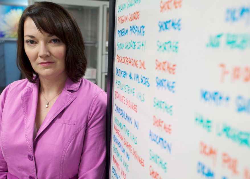 Erin Fox, manager of the Drug Information Service at the University of Utah Hospital in Salt Lake City, stands by a board listing drugs in short supply. "The shortages aren't resolving. They're piling up on top of existing ones," she said. (Associated Press)