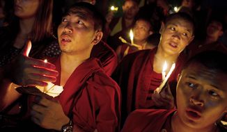 Exiled Tibetan monks hold a candlelight vigil in Dharmsala, India, as they react to news reports of self-immolation by two Tibetan monks at the Kirti Monastery in China&#x27;s Sichuan province. The two monks, who are in stable condition after being rescued by police, called out &quot;long live the Dalai Lama,&quot; according to Free Tibet. (Associated Press)