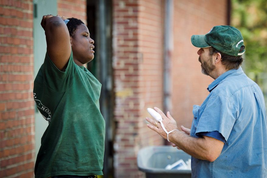 MENTORING: Apprentice Darel Bellamy (left) has a heart-to-heart talk with former DEA agent Fred Geiger, whom he considers a second father, at the Alexandria Seaport Foundation in Alexandria. (Rod Lamkey Jr./The Washington Times)