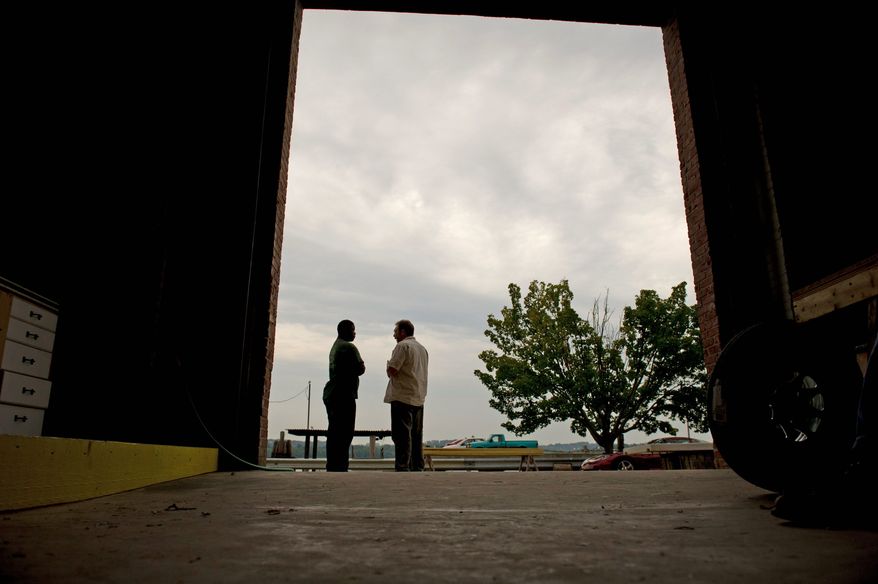 Alexandria Seaport Foundation apprentice Darel Bellamy (left) speaks with volunteer Fred Geiger, a former Drug Enforcement Administration officer. "It's more than donating time," Mr. Geiger said. "It's donating a piece of your experience and a piece of your life to somebody who may be missing that piece." (Rod Lamkey Jr./The Washington Times)