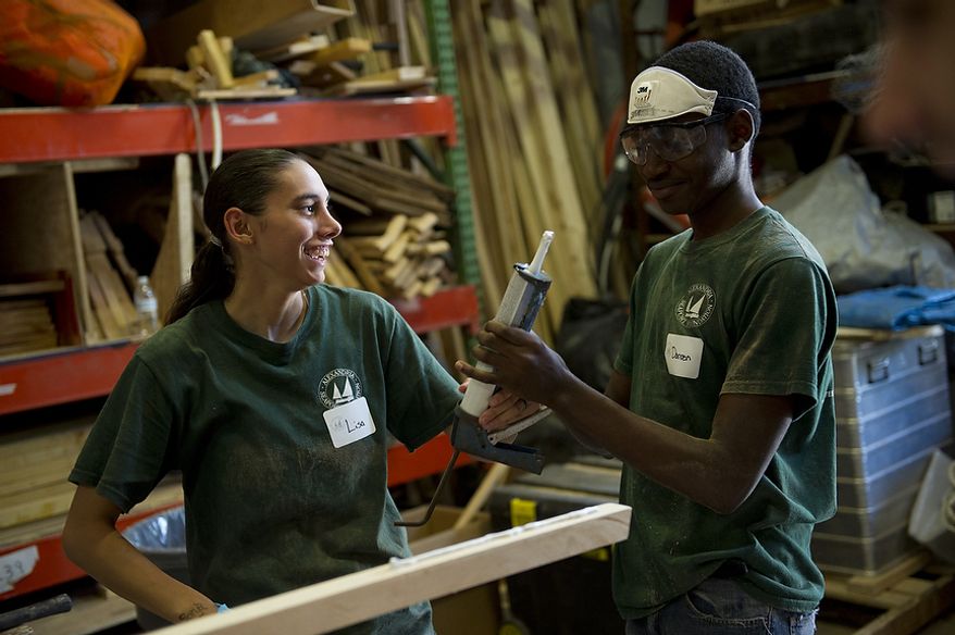 Alexandria Seaport Foundation apprentices Lisa Lukshaw (left) and Darren Walters chat while working on a portion of a small boat in Alexandria, Va., Tuesday, June 28, 2011. Located on the waterfront in Old Town Alexandria, the Alexandria Seaport Foundation is a non-profit paid apprenticeship and hands-on educational program which serves at-risk youths ages 17-21. In the program these youths learn life skills, team work and building their self esteem. In the program apprentices learn carpentry skills and planing for career paths, in addition to earning their GED right here. The ASF says that it costs $100,000.00 to detain a juvenile for a year in Virginia, but only $15,000.00 to educate and place an ASF apprentice. The paid staff and numerous volunteers teaches approximately 8-16 students, however today they are working with around 10. The program lasts 5 to 8 months. Every Tuesday night is "Open Shop" a time when the shop is open to the public. (Rod Lamkey Jr/The Washington Times)