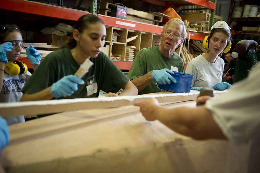 Volunteer Jay Creech (center) keeps an eye on the work as apprentice Lisa Lukshaw (left) and others in the Alexandria Seaport Foundation program work side by side with law student interns building a small boat in Alexandria, Va., Tuesday, June 28, 2011. The law students came there to learn about team work skills. Located on the waterfront in Old Town Alexandria, the Alexandria Seaport Foundation is a non-profit paid apprenticeship and hands-on educational program which serves at-risk youths ages 17-21. In the program these youths learn life skills, team work and building their self esteem. In the program apprentices learn carpentry skills and planing for career paths, in addition to earning their GED right here. The ASF says that it costs $100,000.00 to detain a juvenile for a year in Virginia, but only $15,000.00 to educate and place an ASF apprentice. The paid staff and numerous volunteers teaches approximately 8-16 students, however today they are working with around 10. The program lasts 5 to 8 months. Every Tuesday night is "Open Shop" a time when the shop is open to the public. (Rod Lamkey Jr/The Washington Times)