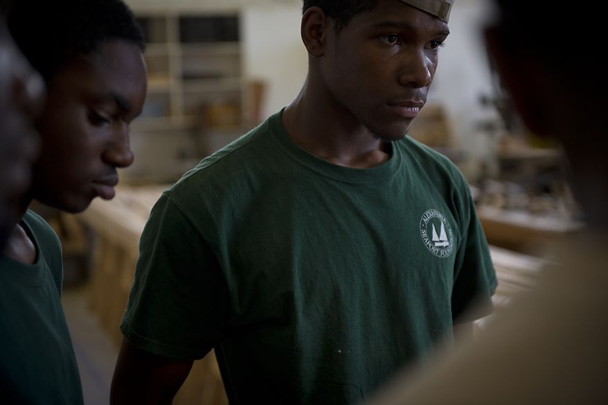 Apprentice Melvin Williams listens to instructions from volunteers at the Alexandria Seaport Foundation in Alexandria, Va., Tuesday, July 5, 2011. Located on the waterfront in Old Town Alexandria, the Alexandria Seaport Foundation is a non-profit paid apprenticeship and hands-on educational program which serves at-risk youths ages 17-21. In the program these youths learn life skills, team work and building their self esteem. In the program apprentices learn carpentry skills and planing for career paths, in addition to earning their GED right here. The ASF says that it costs $100,000.00 to detain a juvenile for a year in Virginia, but only $15,000.00 to educate and place an ASF apprentice. The paid staff and numerous volunteers teaches approximately 8-16 students, however today they are working with around 10. The program lasts 5 to 8 months. Every Tuesday night is "Open Shop" a time when the shop is open to the public. (Rod Lamkey Jr/The Washington Times)
