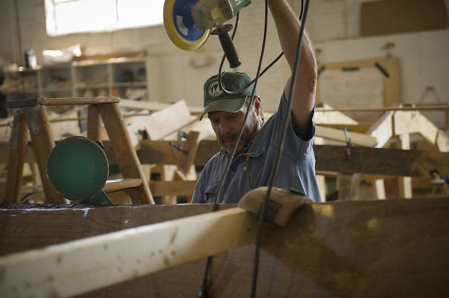 Fred Geiger, a former DEA agent and current volunteer works on one of two dory boats that he and the other volunteers and apprentices are building from scratch at the Alexandria Seaport Foundation in Alexandria, Va., Wednesday, August 24, 2011. Located on the waterfront in Old Town Alexandria, the Alexandria Seaport Foundation is a non-profit paid apprenticeship and hands-on educational program which serves at-risk youths ages 17-21. In the program these youths learn life skills, team work and building their self esteem. In the program apprentices learn carpentry skills and planing for career paths, in addition to earning their GED right here. The ASF says that it costs $100,000.00 to detain a juvenile for a year in Virginia, but only $15,000.00 to educate and place an ASF apprentice. The paid staff and numerous volunteers teaches approximately 8-16 students, however today they are working with around 10. The program lasts 5 to 8 months. Every Tuesday night is "Open Shop" a time when the shop is open to the public. (Rod Lamkey Jr/The Washington Times)