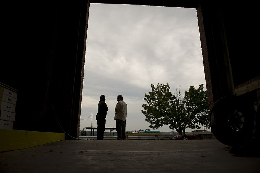 Alexandria Seaport Foundation apprentice Darel Bellamy (left) talks with former DEA agent and current Alexandria Seaport Foundation volunteer Fred Geiger at the Alexandria Seaport Foundation in Alexandria, Va., Wednesday, August 3, 2011. Darel thinks of Mr. Geiger as a "second dad". Located on the waterfront in Old Town Alexandria, the Alexandria Seaport Foundation is a non-profit paid apprenticeship and hands-on educational program which serves at-risk youths ages 17-21. In the program these youths learn life skills, team work and building their self esteem. In the program apprentices learn carpentry skills and planing for career paths, in addition to earning their GED right here. The ASF says that it costs $100,000.00 to detain a juvenile for a year in Virginia, but only $15,000.00 to educate and place an ASF apprentice. The paid staff and numerous volunteers teaches approximately 8-16 students, however today they are working with around 10. The program lasts 5 to 8 months. Every Tuesday night is "Open Shop" a time when the shop is open to the public. (Rod Lamkey Jr/The Washington Times)