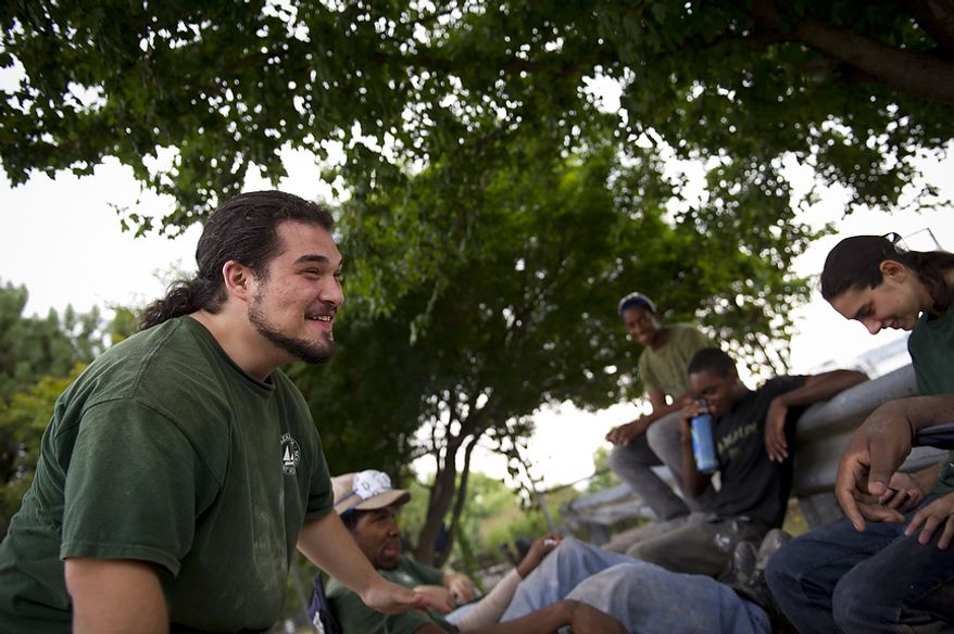 Alexandria Seaport Foundation apprentice and graduate Samuel Morrill shares a laugh with his fellow apprentices during a break from work at the Alexandria Seaport Foundation in Alexandria, Va., Wednesday, August 3, 2011. Located on the waterfront in Old Town Alexandria, the Alexandria Seaport Foundation is a non-profit paid apprenticeship and hands-on educational program which serves at-risk youths ages 17-21. In the program these youths learn life skills, team work and building their self esteem. In the program apprentices learn carpentry skills and planing for career paths, in addition to earning their GED right here. The ASF says that it costs $100,000.00 to detain a juvenile for a year in Virginia, but only $15,000.00 to educate and place an ASF apprentice. The paid staff and numerous volunteers teaches approximately 8-16 students, however today they are working with around 10. The program lasts 5 to 8 months. Every Tuesday night is "Open Shop" a time when the shop is open to the public. (Rod Lamkey Jr/The Washington Times)
