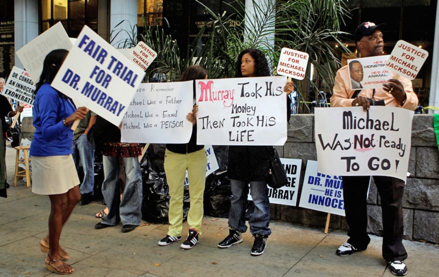 Demonstrators for and against make their case outside the involuntary manslaughter trial for Dr. Conrad Murray. (AP Photo/Reed Saxon)