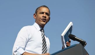 President Obama holds ups his proposed American Jobs Act legislation while speaking at Abraham Lincoln High School in Denver on Sept. 27, 2011. (Associated Press)