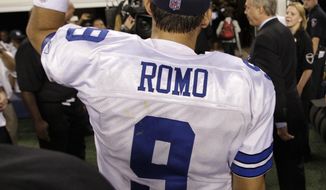 **FILE** Dallas Cowboys quarterback Tony Romo acknowledges cheers from fans as he walks off the field following their 18-16 win over the Washington Redskins on Sept. 26, 2011, in Arlington, Texas. (Associated Press)