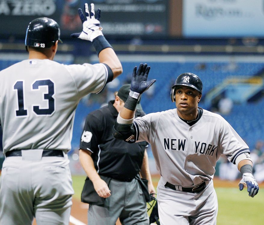 Robinson Cano (right) and the Yankees are guaranteed of opening an American League first-round series at home Friday night. (Associated Press)