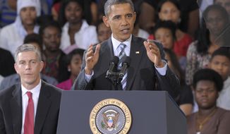 President Obama, accompanied by Education Secretary Arne Duncan (left), delivers his back-to school speech on Sept. 28, 2011, at Benjamin Banneker Academic High School in D.C. (Associated Press)