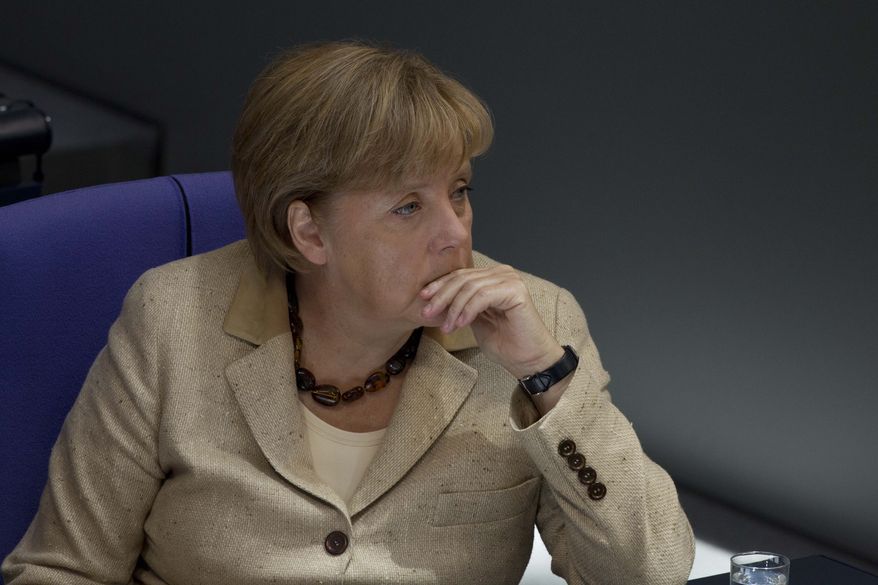 German Chancellor Angela Merkel listens to the debate on the eurozone bailout fund in the Bundestag, the lower legislative house, at the Reichstag in Berlin on Thursday, Sept. 29, 2011. (AP Photo/Markus Schreiber)