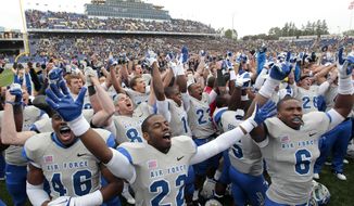 Air Force players celebrate with the crowd after defeating Navy 35-34 in overtime in an NCAA college football game, Saturday, Oct 1, 2011, in Annapolis, Md. (AP Photo/Luis M. Alvarez)