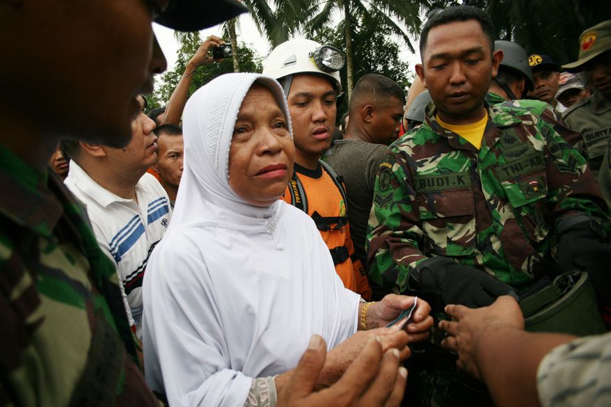 A relative of a plane crash victim cries in Bahorok, Nort Sumatra, Friday, Sept 30, 2011. (AP Photo/Binsar Bakkara)