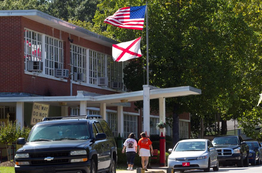 ** FILE ** Mothers arrive to pick up their children from Flowers School in Montgomery, Ala. (Associated Press)