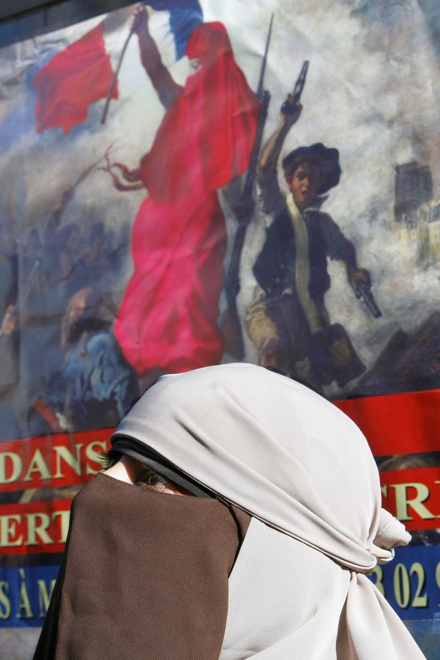 Kenza Drider, wearing an Islamic face veil, announces late last month in front of Meaux courthouse, east of Paris, that she will be candidate in the 2012 French presidential elections. Ms. Drider declared her longshot candidacy on the same day that a French court fined two women who refused to remove their veils. (Associated Press)