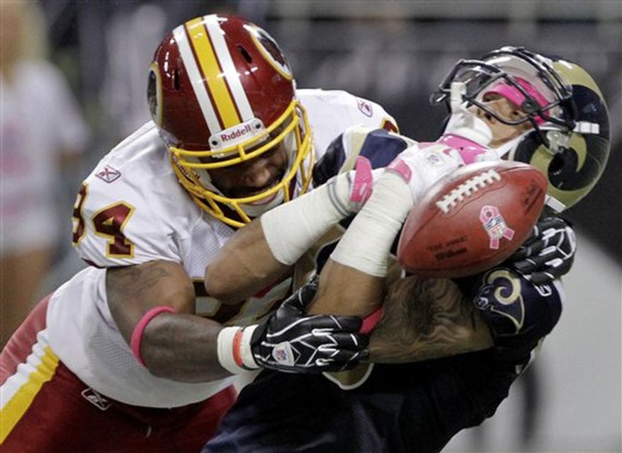 St. Louis Rams' Austin Pettis, right, loses the ball on a punt return as he is hit by Washington Redskins' Niles Paul during the second quarter of the NFL football game Sunday, Oct. 2, 2011, in St. Louis. The Rams recovered the ball and Paul was charged with an unnecessary roughness penalty on the play. (AP Photo/Seth Perlman)