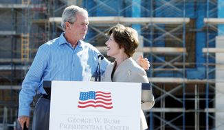 ** FILE ** Former first lady Laura Bush introduces her husband, former President George W. Bush, at the &quot;topping out&quot; ceremony of his library on the campus of Southern Methodist University in Dallas. (Associated Press)