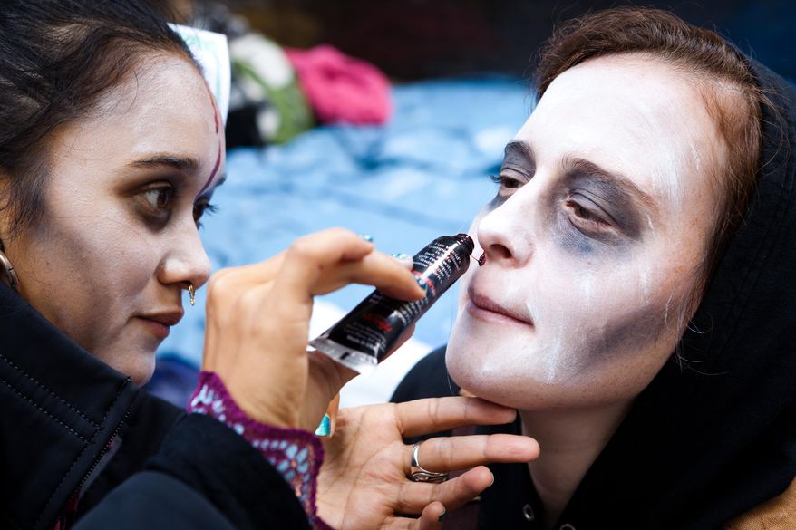 Rachel Schneider of Brooklyn, N.Y., has her face painted to resemble a zombie before a march Oct. 3, 2011, at the ongoing Occupy Wall Street demonstration in Zucotti Park, located in New York's financial district. (Associated Press)