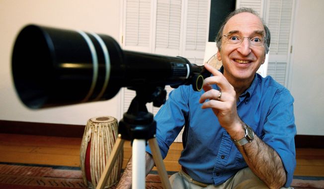 Saul Perlmutter, at his home in Berkeley, Calif., is all smiles Tuesday after learning he had won the Nobel Prize in physics. He shared the prize with Brian Schmidt and Adam Riess for their work mapping the universe&#x27;s expansion by analyzing a particular type of supernova, or exploding star. (Associated Press)