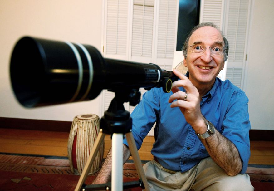 Saul Perlmutter, at his home in Berkeley, Calif., is all smiles Tuesday after learning he had won the Nobel Prize in physics. He shared the prize with Brian Schmidt and Adam Riess for their work mapping the universe's expansion by analyzing a particular type of supernova, or exploding star. (Associated Press)