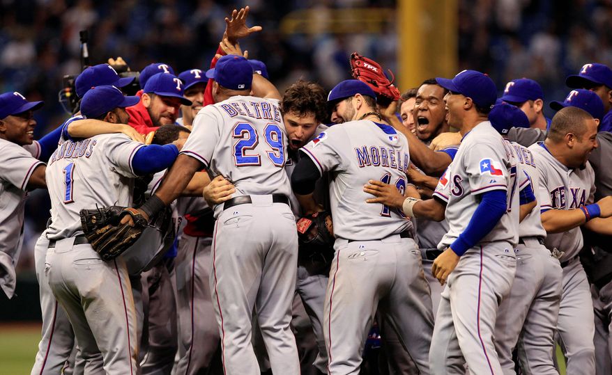 Rangers players celebrated their 4-3 win over the Tampa Bay Rays on Tuesday that clinched a return trip to the ALCS. (Associated Press)