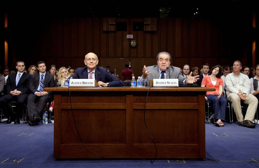 Supreme Court Justices Stephen G. Breyer and Antonin Scalia discuss their differing views of the Constitution before the Senate Judiciary Committee on Wednesday. (Associated Press)