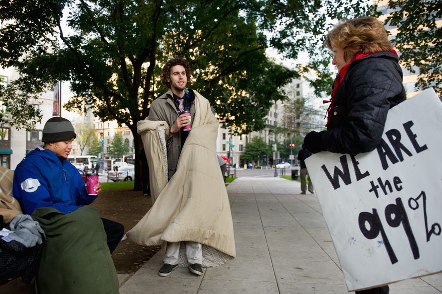 Protesters (from left) Justin Rodriguez, Eric Sponaugle and Lacy MacAuley chat Wednesday at McPherson Square. The three are among a few protesters loosely tied to Occupy D.C. who have been protesting by day and sleeping on sidewalks by night at the square not far from the White House. (Andrew Harnik/The Washington Times)