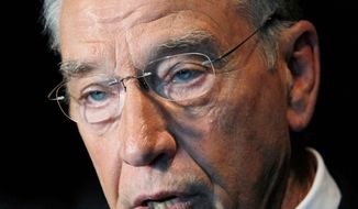 Sen. Chuck Grassley, Iowa Republican, wants to know why a well-traveled Justice official wasn&#39;t fired. (Associated Press)