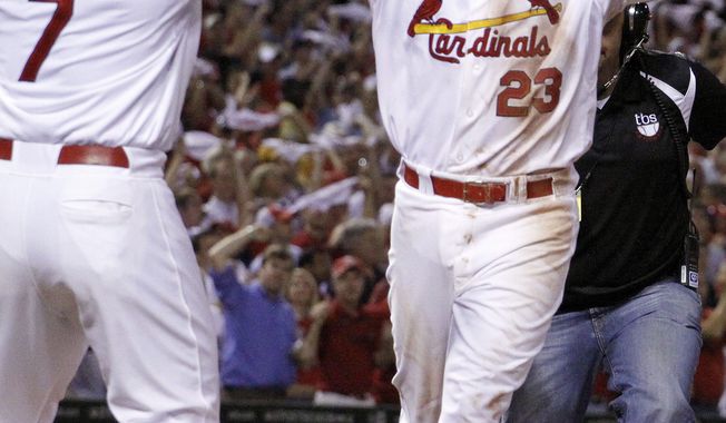 St. Louis Cardinals&#x27; David Freese, right, is congratulated by teammate Matt Holliday after hitting a two-run home run during the sixth inning of Game 4 of baseball&#x27;s National League division series against the Philadelphia Phillies, Wednesday, Oct. 5, 2011, in St. Louis. (AP Photo/Jeff Roberson)