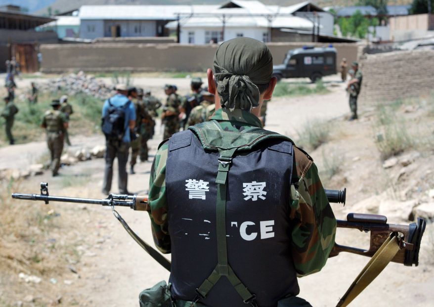 **FILE** Kyrgyz soldiers conduct a foot patrol on June 20, 2010, in the village of Surattash, 10 miles from the southern Kyrgyz city of Osh, Kyrgyzstan, near the border of Kyrgyzstan and Uzbekistan. (Associated Press)