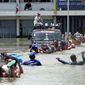 ASSOCIATED PRESS
Prisoners at Ayutthaya province prison in central Thailand wade in chest-deep water to board a bus Thursday during an evacuation as storms continue to flood the area. Other countries in Southeast Asia also have endured the worst flooding in 50 years.