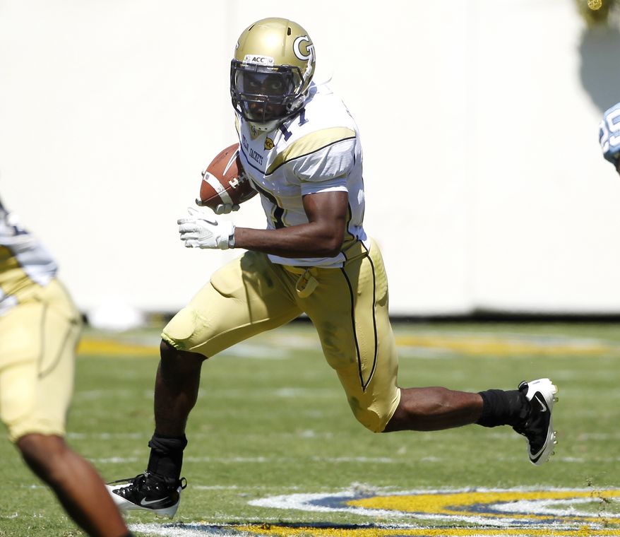 This Sept. 24, 2011 file photo shows Georgia Tech's Orwin Smith looking for running room during an NCAA college football game against North Carolina, in Atlanta. The Yellow Jackets' roll through five wins has inspired such momentum that running back Smith proclaimed he couldn't wait to play Clemson and Virginia Tech - even though Maryland visits Atlanta this week. (AP Photo/John Bazemore, File)