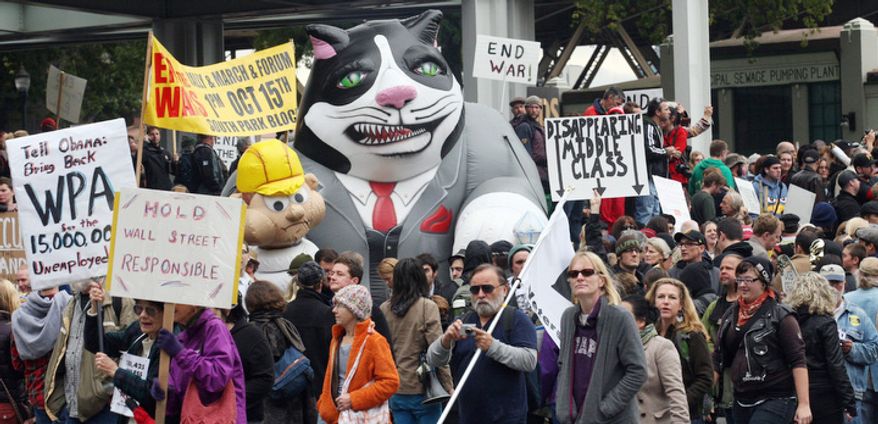 Demonstrators supporting the Occupy Wall Street movement against corporate power protest Thursday, Oct. 6 2011, at Tom McCall Waterfront Park, in Portland, Ore. Police expect the Occupy Portland demonstrators will march downtown Thursday afternoon, disrupting traffic and businesses. (AP Photo/Rick Bowmer)