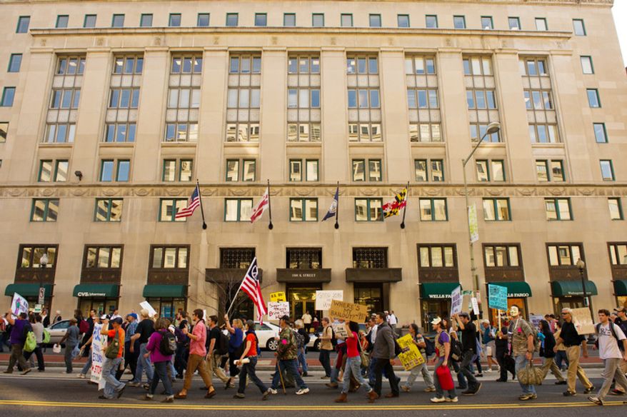 Hundreds of protesters march along K Street in Washington, DC, October 6, 2011. (Andrew Harnik / The Washington Times)