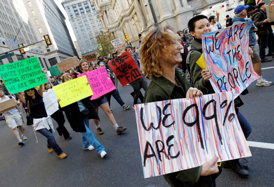 People march near City Hall Thursday, Oct. 6, 2011 in Philadelphia. Organizers of what is being called Occupy Philadelphia say Thursday's demonstration is meant to be a stand against corporate greed. (AP Photo/Alex Brandon)