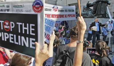 Mike Tidwell (right) from the Chesapeake Climate Action Network addresses a rally outside the Ronald Reagan Building in Washington on Oct., 7, 2011, against the proposed Keystone XL pipeline. (Associated Press)
